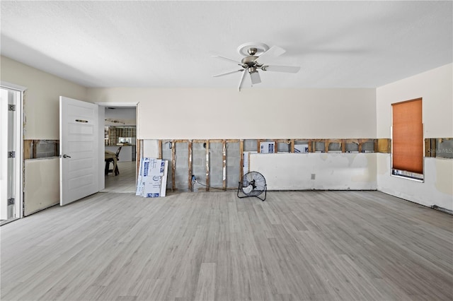 empty room with ceiling fan and light hardwood / wood-style flooring