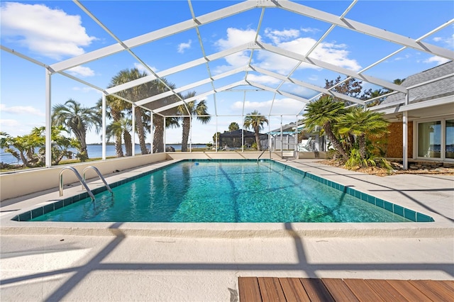 view of pool featuring a lanai, a water view, and a patio