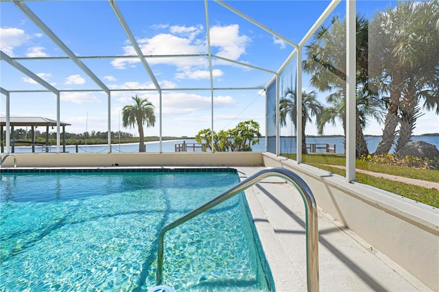 view of swimming pool featuring a lanai and a water view