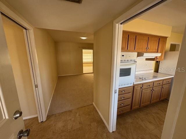 kitchen featuring white oven and black electric stovetop