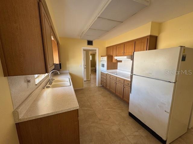 kitchen featuring sink and white appliances