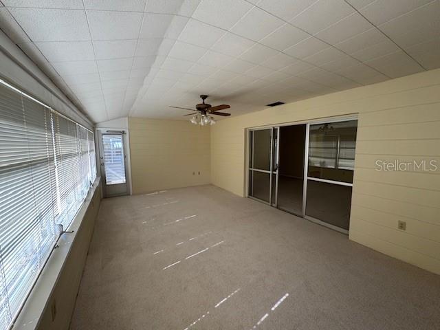 unfurnished sunroom featuring ceiling fan and lofted ceiling