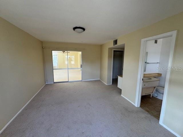 unfurnished room with light carpet