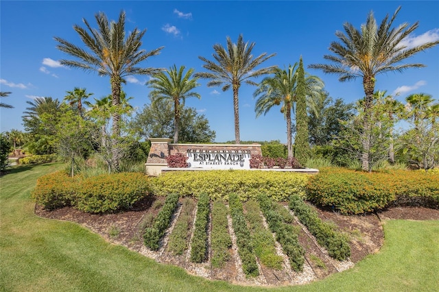 community / neighborhood sign with a lawn