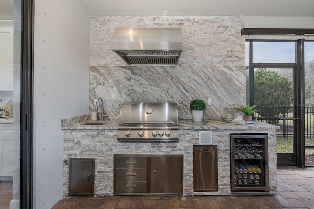 view of patio / terrace featuring area for grilling, sink, and wine cooler