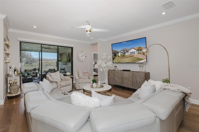 living room featuring wood-type flooring, crown molding, and ceiling fan