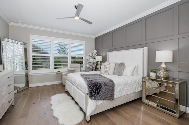 bedroom with crown molding, ceiling fan, and hardwood / wood-style flooring