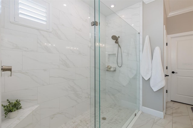 bathroom featuring ornamental molding and tiled shower