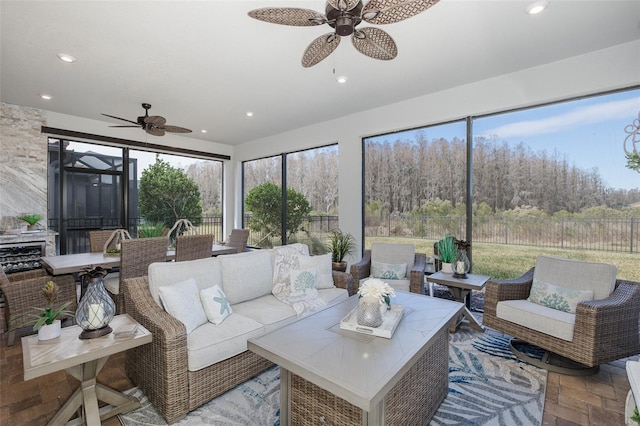 sunroom / solarium featuring ceiling fan