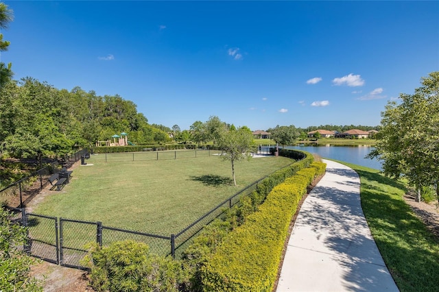 view of community with a water view and a yard