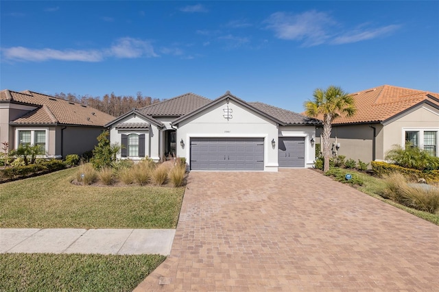 mediterranean / spanish-style house with a garage and a front yard