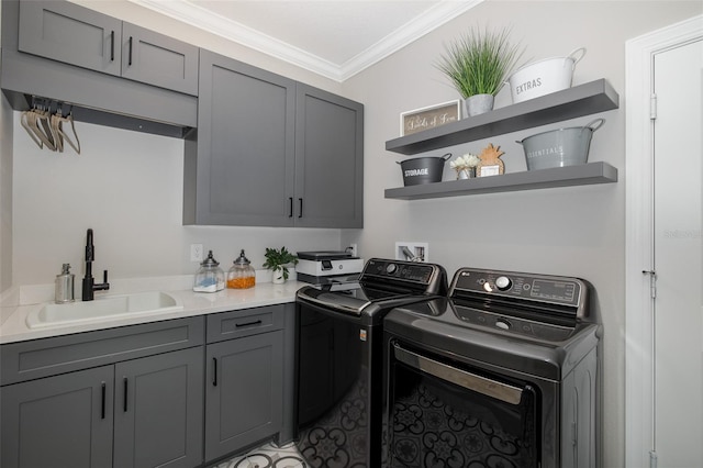 laundry area featuring sink, crown molding, cabinets, and independent washer and dryer