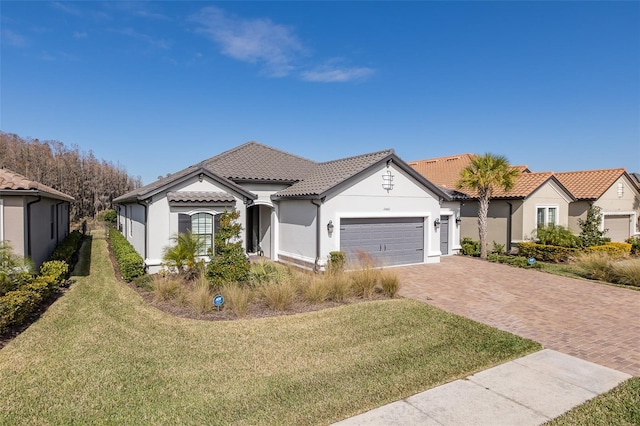 mediterranean / spanish home with a garage and a front lawn