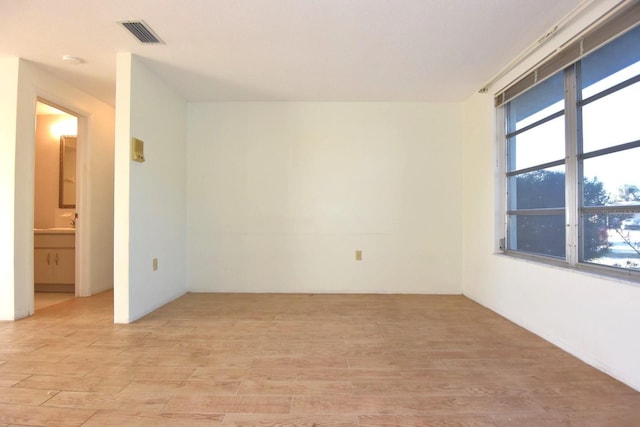 spare room featuring light wood-type flooring