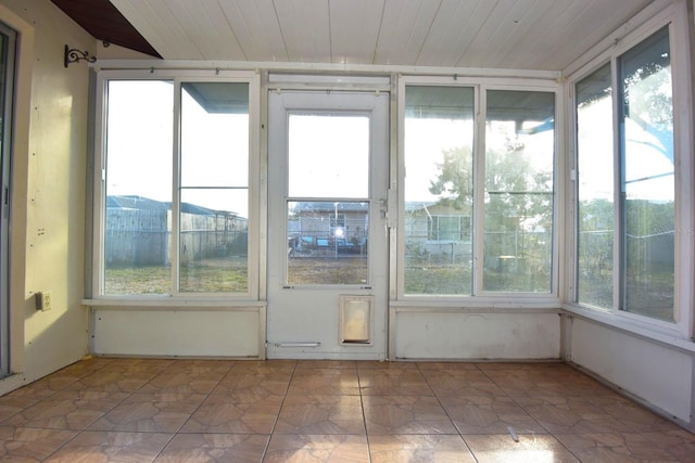 unfurnished sunroom featuring wooden ceiling