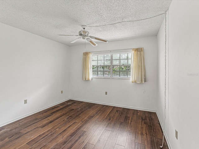 empty room featuring ceiling fan, dark hardwood / wood-style floors, and a textured ceiling