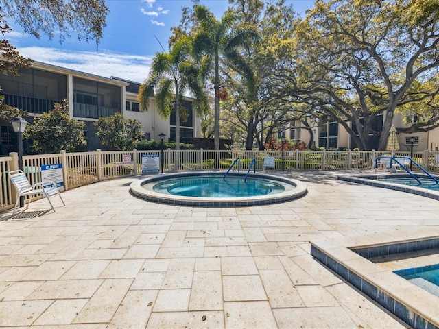 view of swimming pool with a community hot tub and a patio