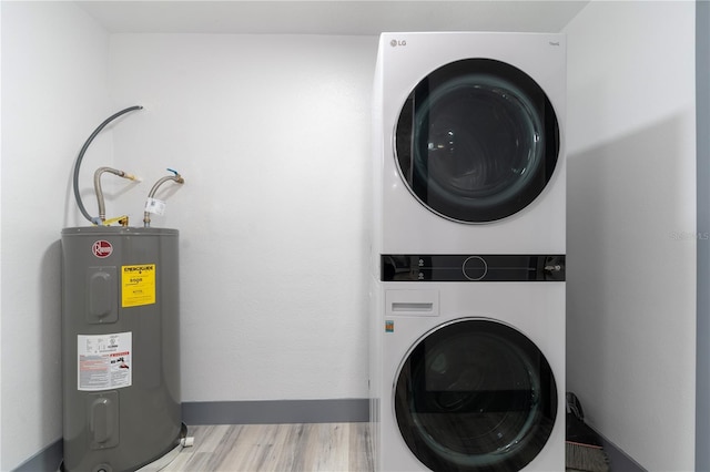 clothes washing area featuring water heater, stacked washer and clothes dryer, and light hardwood / wood-style flooring