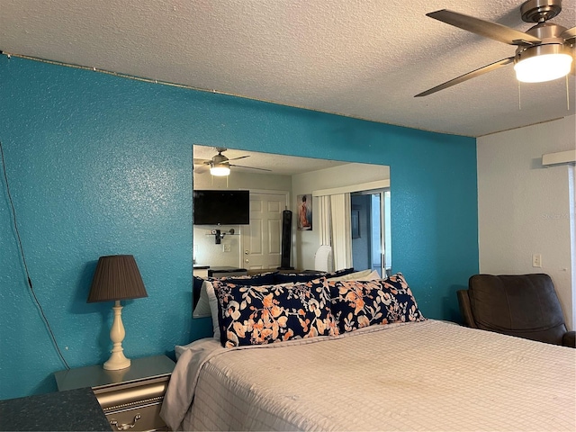 bedroom with a textured ceiling and ceiling fan