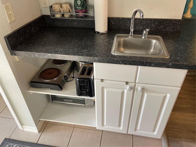 room details featuring white cabinetry and sink