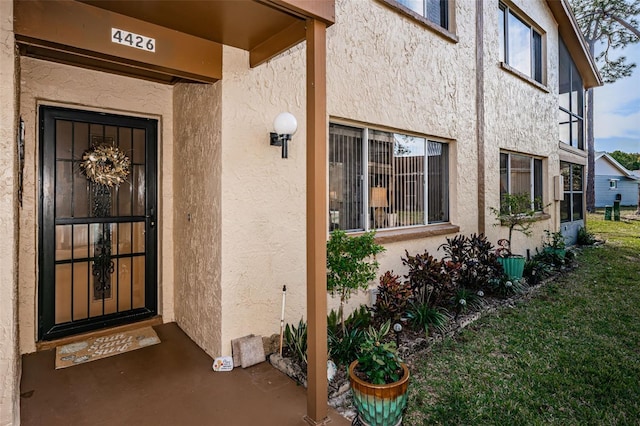 entrance to property featuring a yard