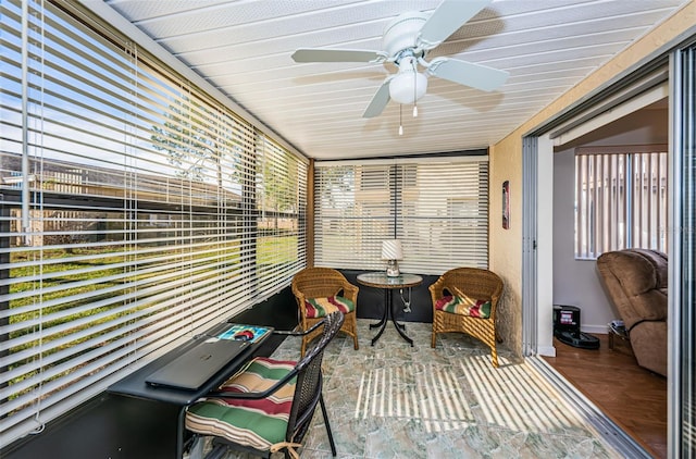 sunroom / solarium featuring plenty of natural light and ceiling fan