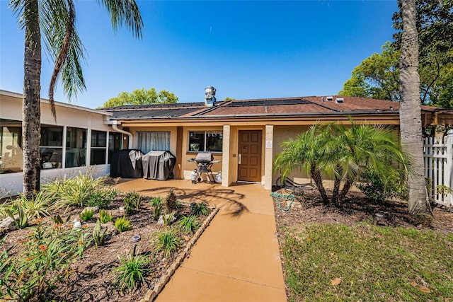 view of front of property with a sunroom and a patio