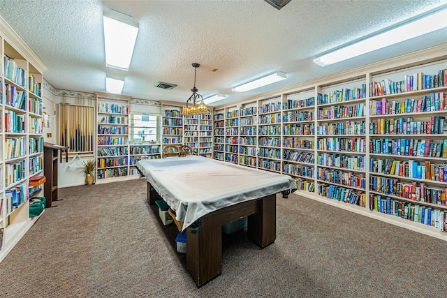 rec room featuring a textured ceiling and carpet flooring