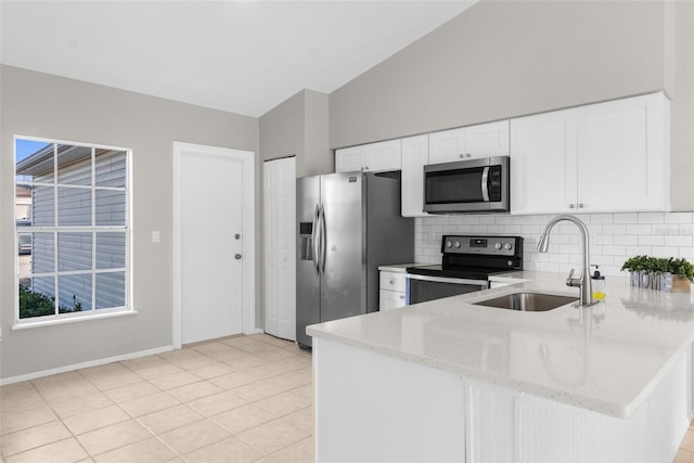 kitchen featuring light stone countertops, sink, white cabinetry, and stainless steel appliances