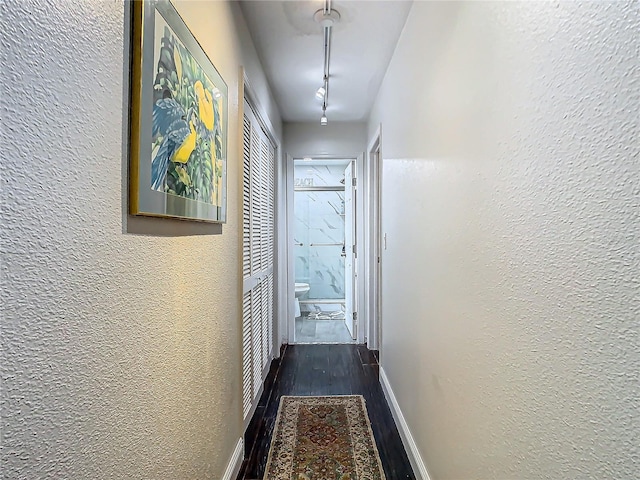 12529 Shadow Ridge Blvd, Hudson, FL 34669 - hall with dark wood-style flooring, a textured wall, and baseboards
