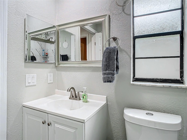 12529 Shadow Ridge Blvd, Hudson, FL 34669 - bathroom with a textured wall, vanity, and toilet
