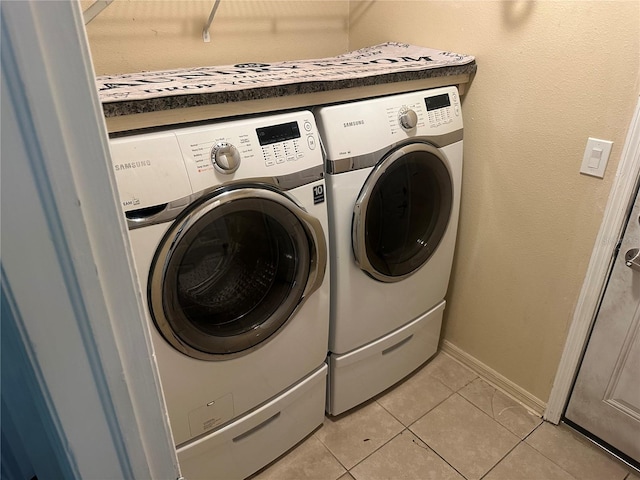 12529 Shadow Ridge Blvd, Hudson, FL 34669 - laundry room with washing machine and dryer, light tile patterned floors, and baseboards