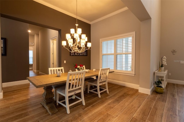 dining room featuring crown molding, an inviting chandelier, and wood-type flooring