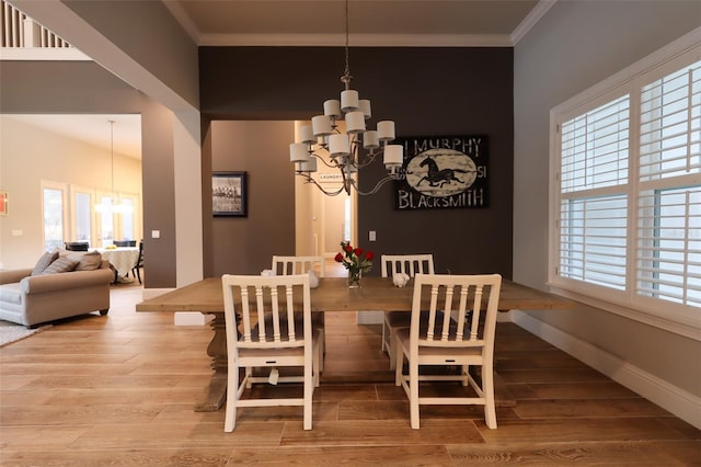 dining room featuring a chandelier, crown molding, and hardwood / wood-style floors