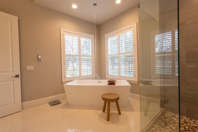 bathroom featuring plus walk in shower and tile patterned flooring