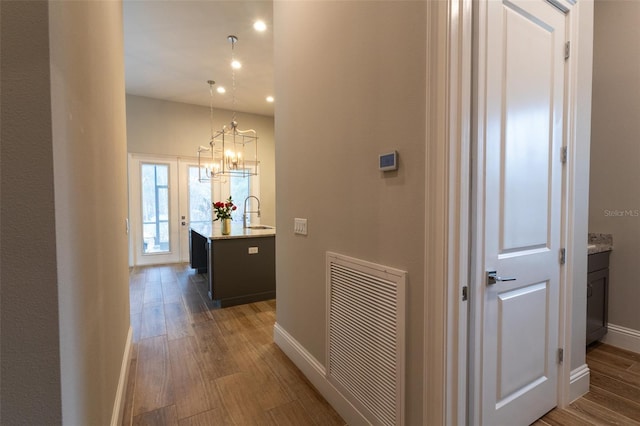 hallway featuring sink and dark hardwood / wood-style flooring