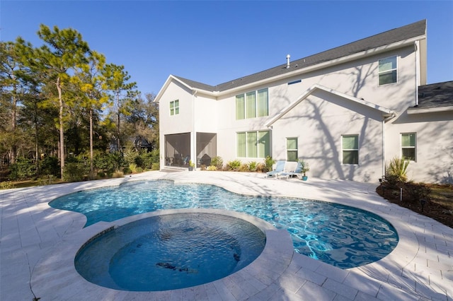 view of pool featuring an in ground hot tub and a patio area