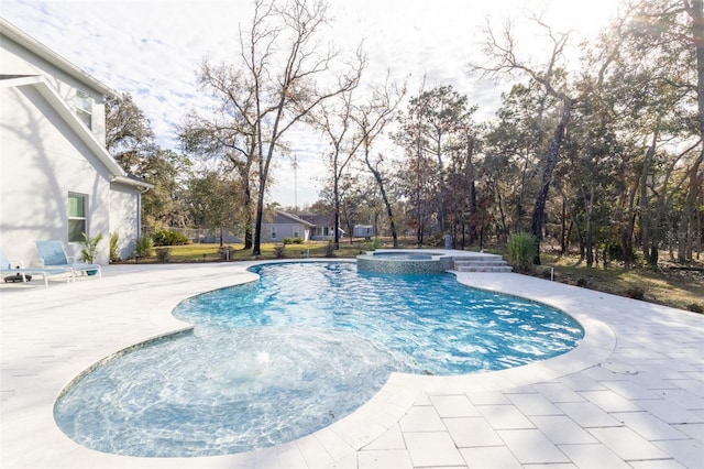 view of pool featuring an in ground hot tub and a patio area