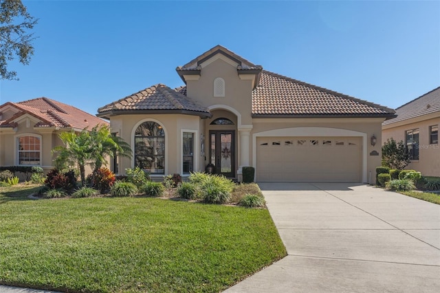 mediterranean / spanish-style house with a garage and a front yard