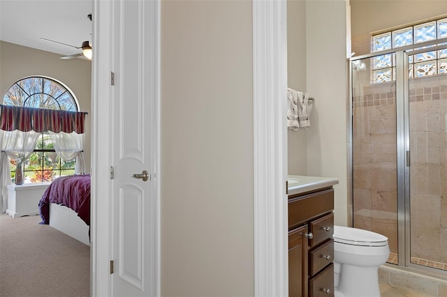 bathroom featuring an enclosed shower, vanity, toilet, and ceiling fan