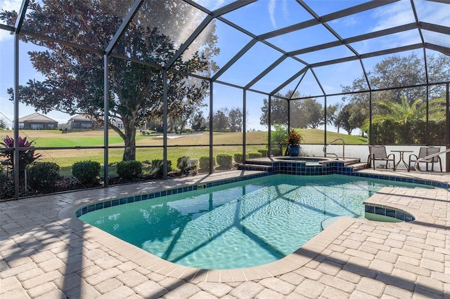 view of pool with an in ground hot tub, a lanai, and a patio area