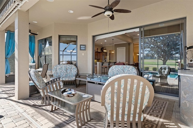 view of patio featuring ceiling fan