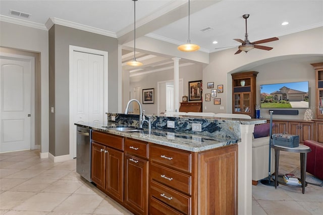 kitchen with sink, hanging light fixtures, light stone counters, a center island with sink, and stainless steel dishwasher