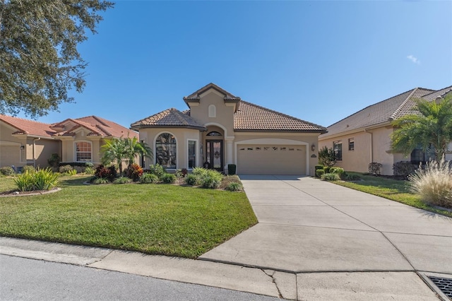 mediterranean / spanish home featuring a garage and a front lawn