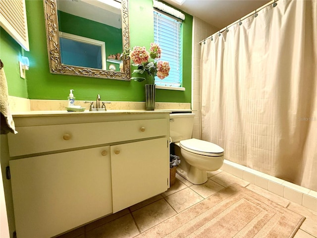 bathroom with vanity, tile patterned floors, and toilet