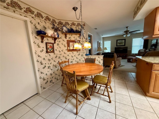 tiled dining room featuring ceiling fan