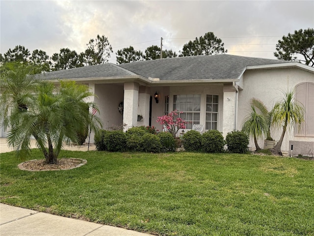 8111 Merrimac Dr, Port Richey, FL 34668 - single story home featuring a front lawn, stucco siding, and a shingled roof
