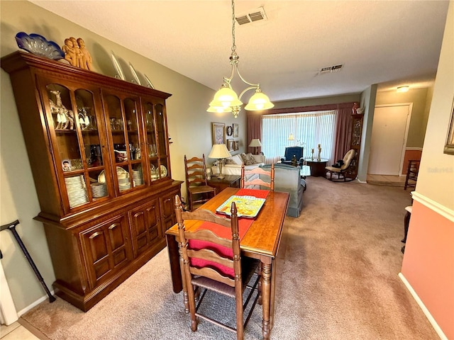 8111 Merrimac Dr, Port Richey, FL 34668 - dining room featuring light carpet and baseboards