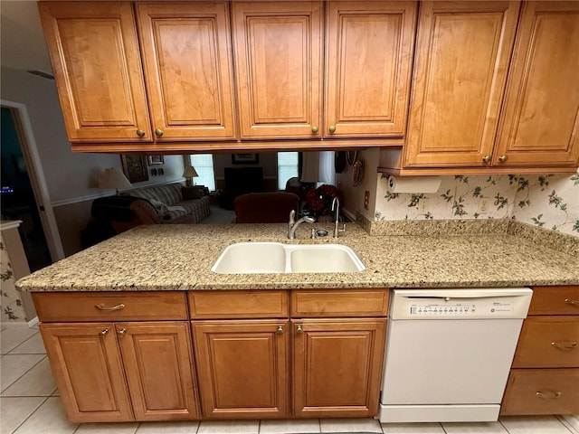 8111 Merrimac Dr, Port Richey, FL 34668 - kitchen with dishwasher, a sink, light stone countertops, and brown cabinets
