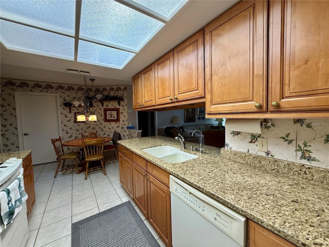 8111 Merrimac Dr, Port Richey, FL 34668 - kitchen with wallpapered walls, white appliances, a sink, brown cabinets, and light tile patterned flooring